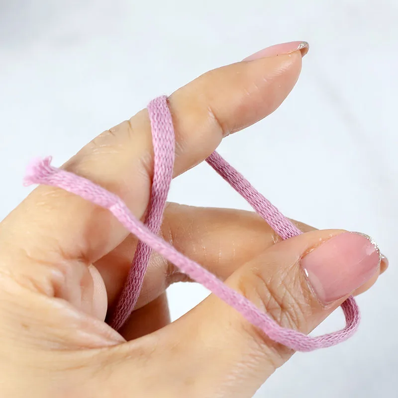 Bring the yarn tail across and toward your index finger