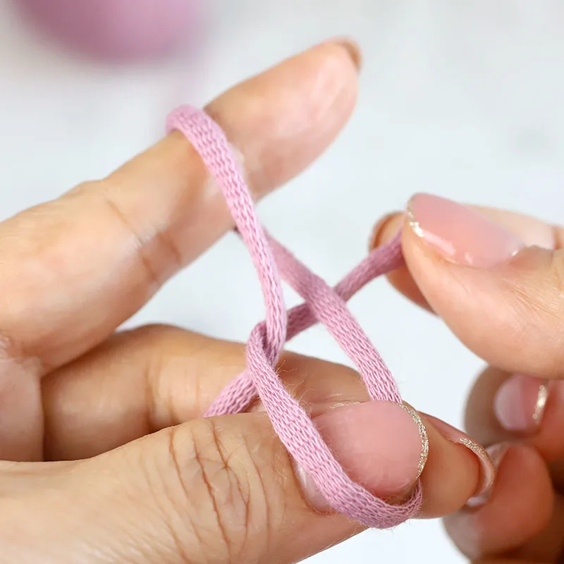 Pull the yarn tail to bring it across.