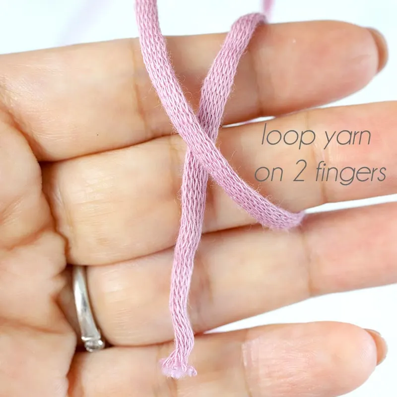 Place the yarn on the palm of your left hand with the loose end pointing down. Wrap the working yarn around your index and middle fingers.