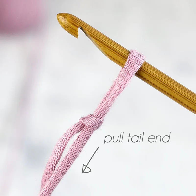 Pull the tail end of the yarn to make the knot tighter.