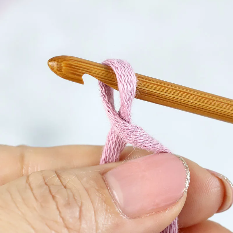 Hook rotation produces a crossed strand beneath the loop.