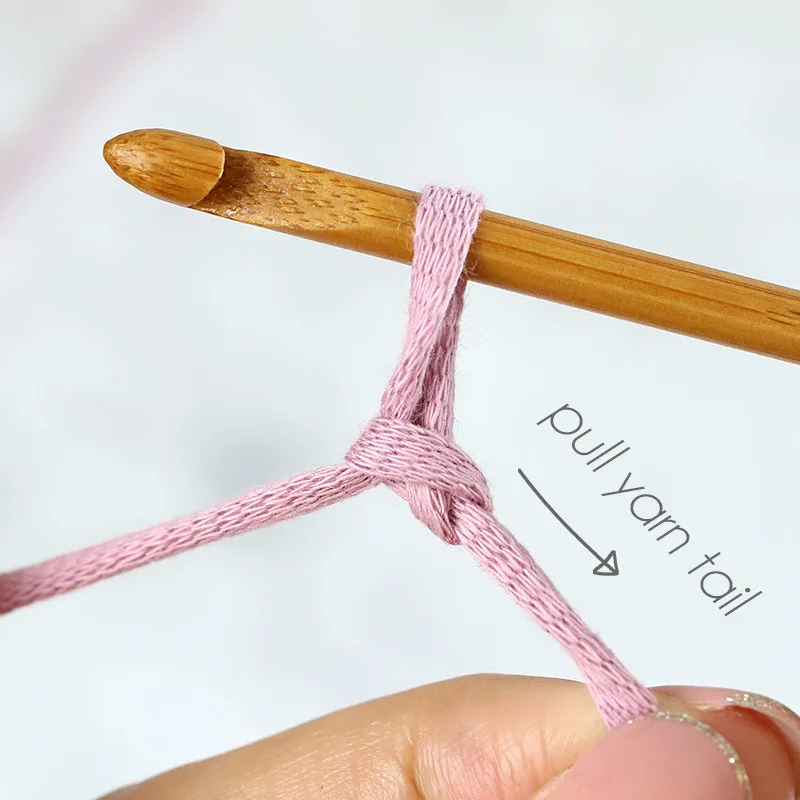 Pull the tail end of the yarn to make the knot tighter.