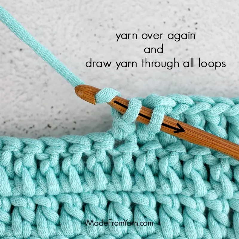 how to crochet dc stitch step 7, yarn over again, and draw yarn through all loops