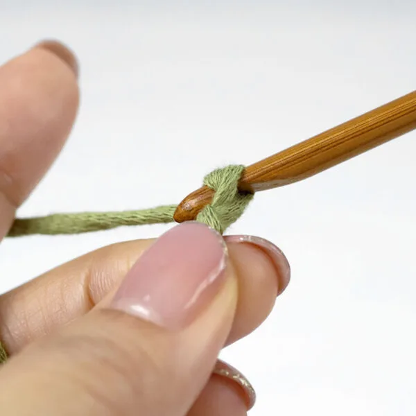 pull the working yarn through the loop on the hook to make a chain stitch.