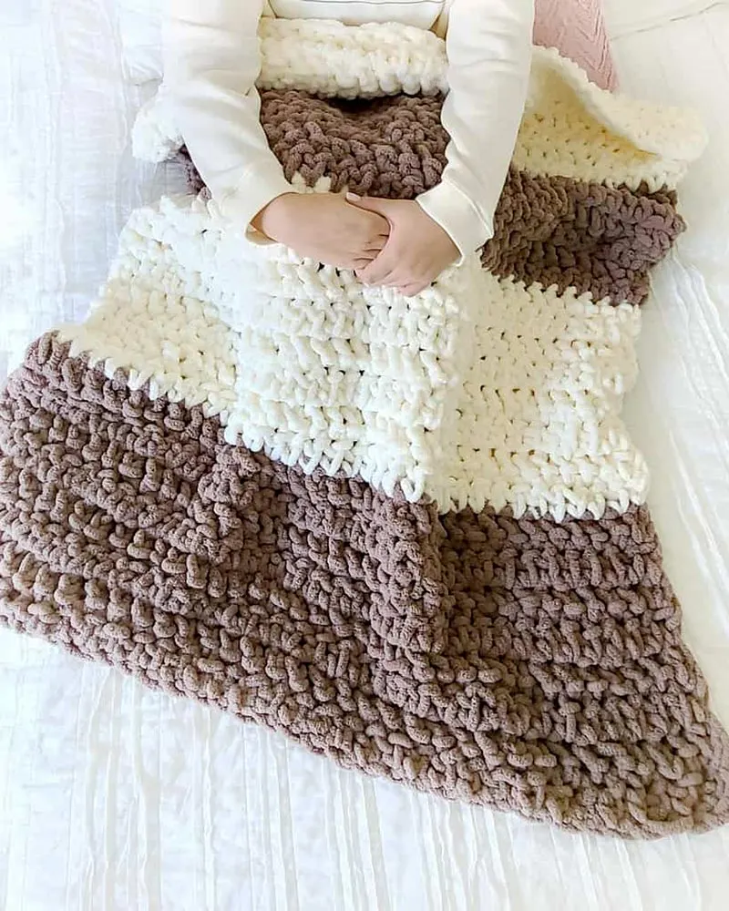 Indulge in the plush texture and vibrant colors of this yarn as you craft snug blankets perfect for chilly evenings.