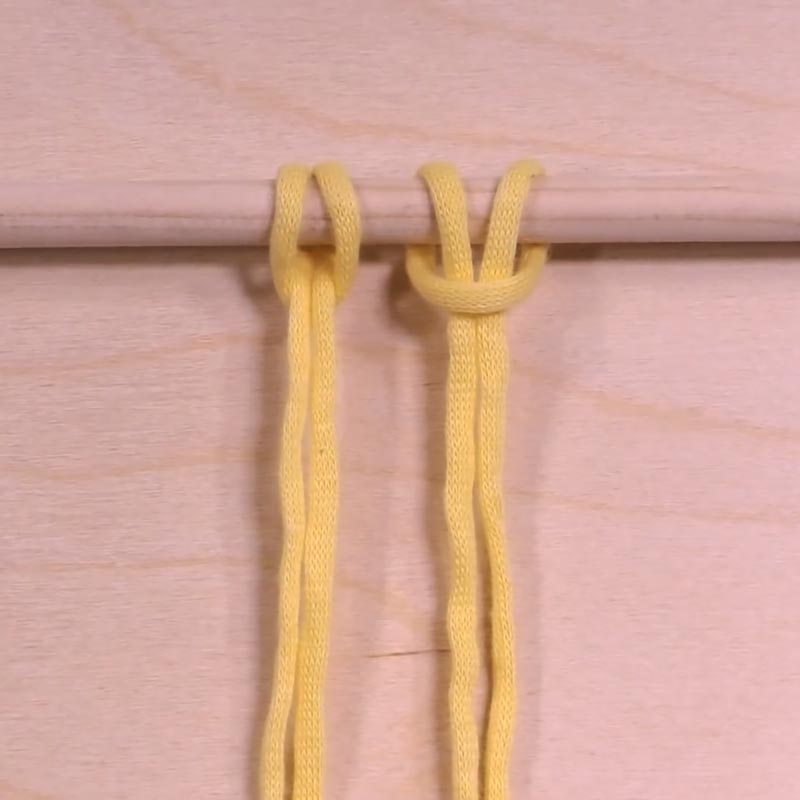 First and foremost, if you're wondering how to macrame and where to begin, most designs and patterns would start with the Lark's Head Knot. This is a mounting knot, meaning it forms the base of your projects as you attach your cords to your dowels. 