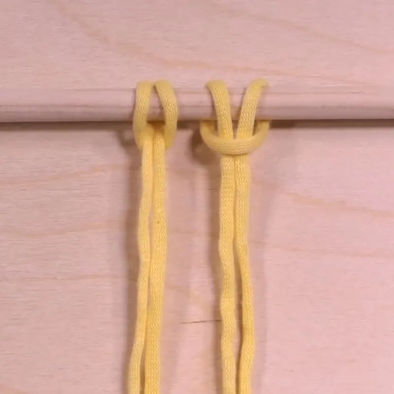 First and foremost, if you're wondering how to macrame and where to begin, most designs and patterns would start with the Lark's Head Knot. This is a mounting knot, meaning it forms the base of your projects as you attach your cords to your dowels.