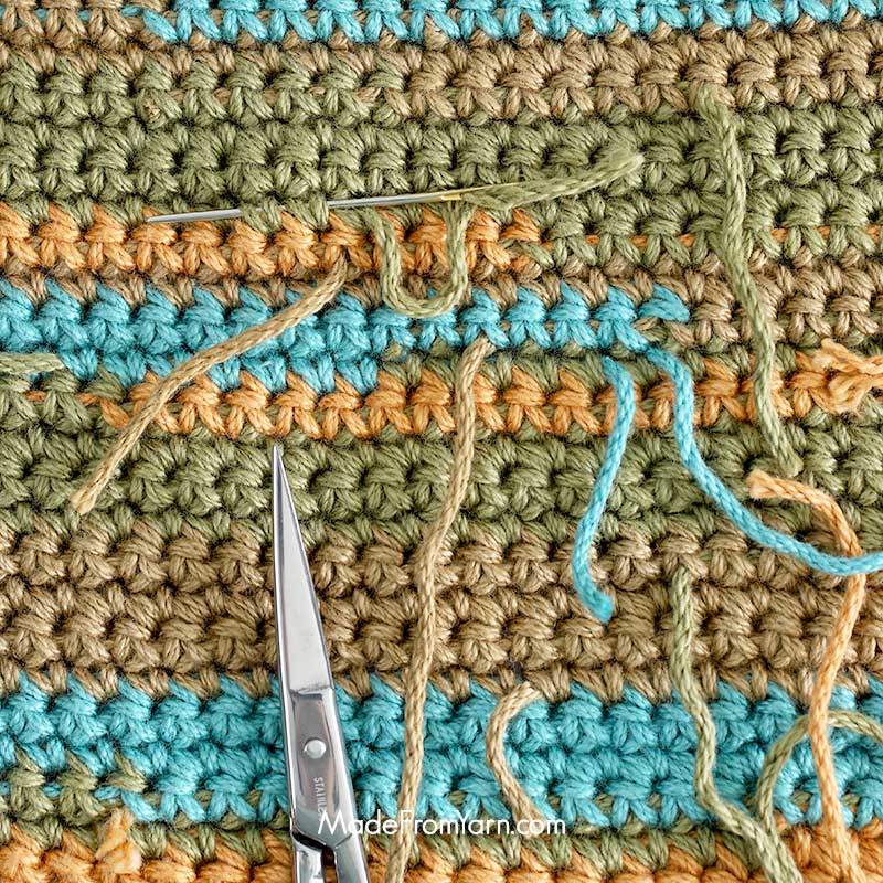 it's typical to crochet over the yarn tail for short distances along the back of your work. Once the project is complete, simply weave any visible tails into the stitches to neatly conceal them.