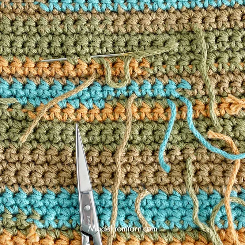 it's typical to crochet over the yarn tail for short distances along the back of your work. Once the project is complete, simply weave any visible tails into the stitches to neatly conceal them.