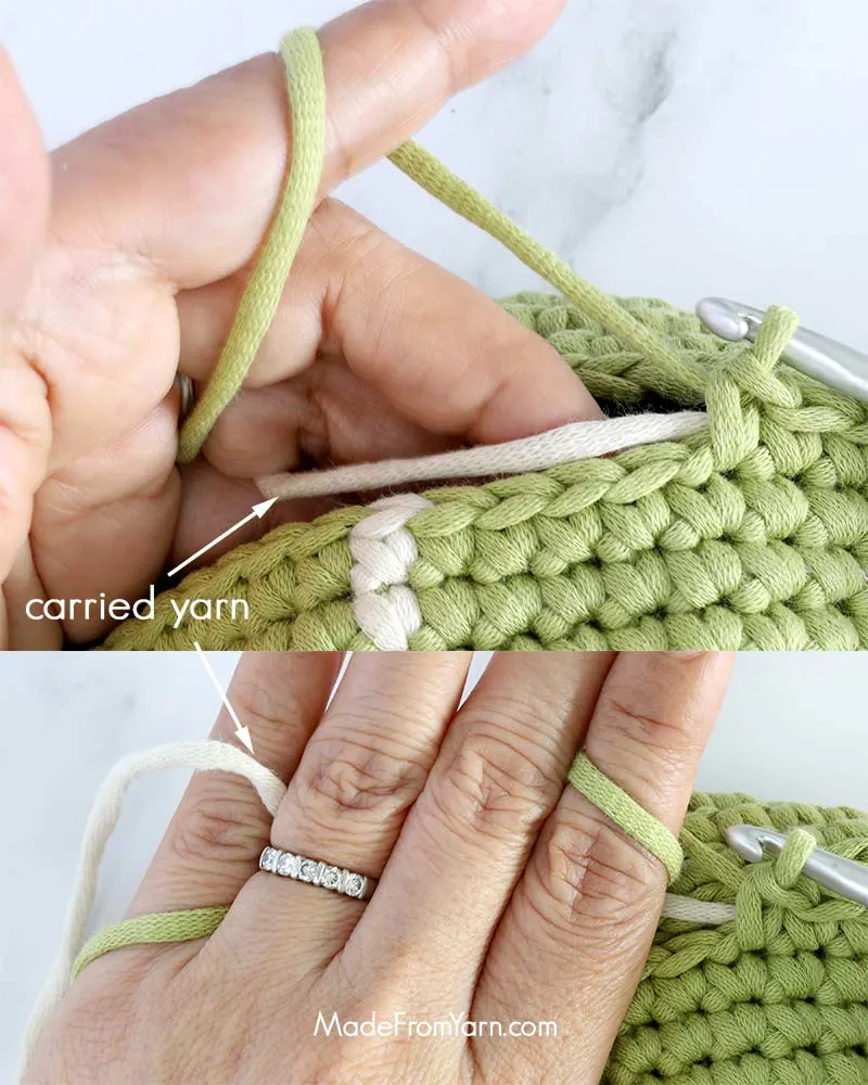 When crocheting with multiple yarns in tapestry crochet, it’s helpful to hold the unused yarn in tension to keep it smooth and manageable. To do this, drape the unused yarn across the top of your stitches and hold it lightly behind your work.